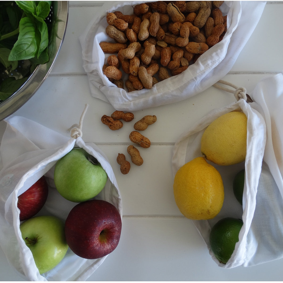 4MyEarth Bamboo produce bag set shown withnuts, lemons, limes &amp; apples.  