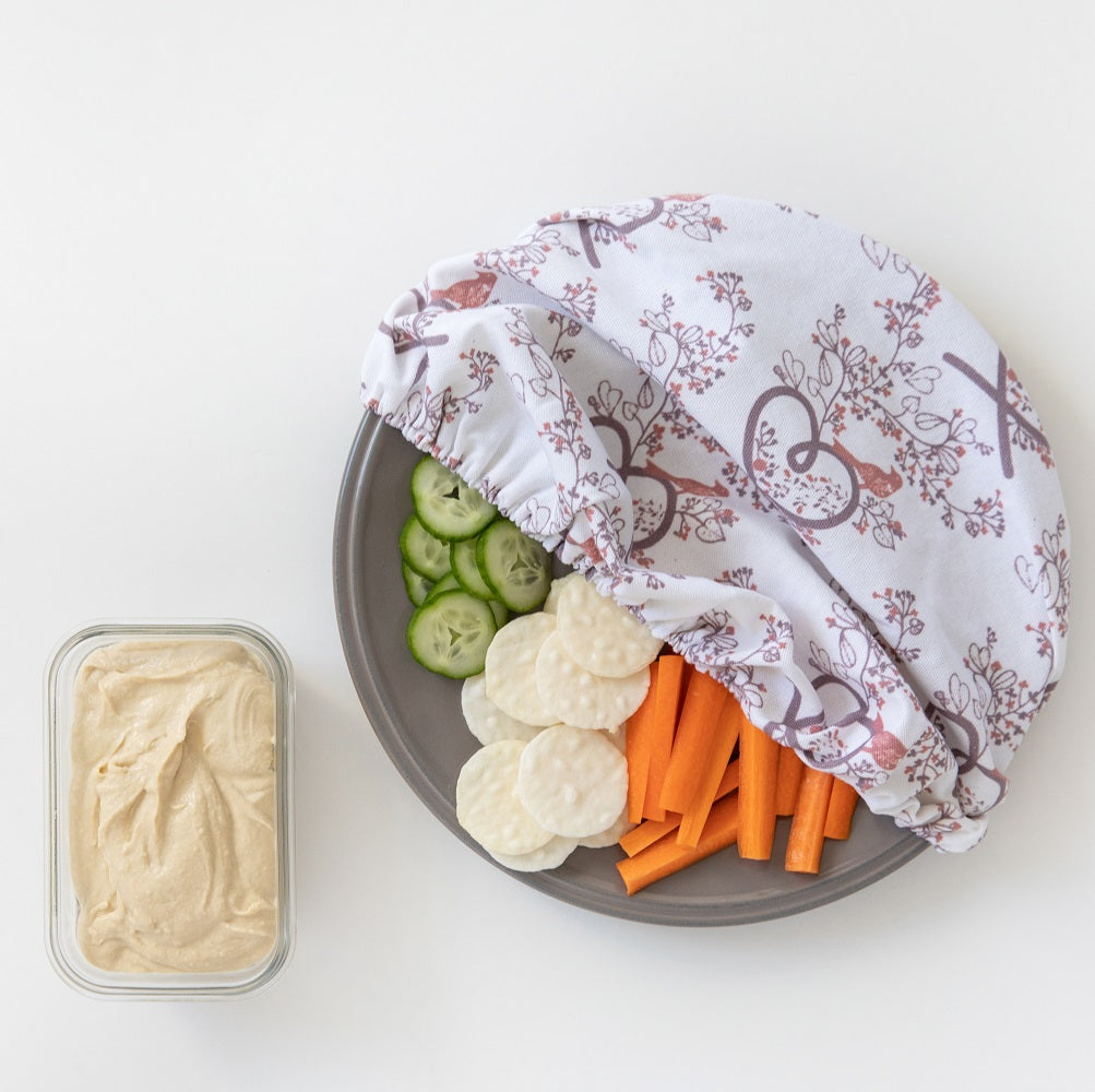 4MyEarth Food Cover XL in Autumn Birds print covering a veggie platter with humous